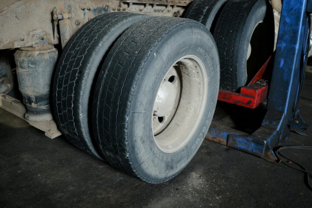 Close-up of truck tires in a garage awaiting maintenance. Industrial setting with a focus on wheels.